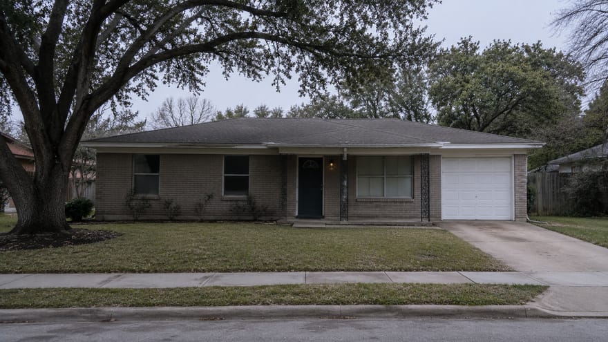 Mid-century brick ranch home under a live oak, Houston Texas